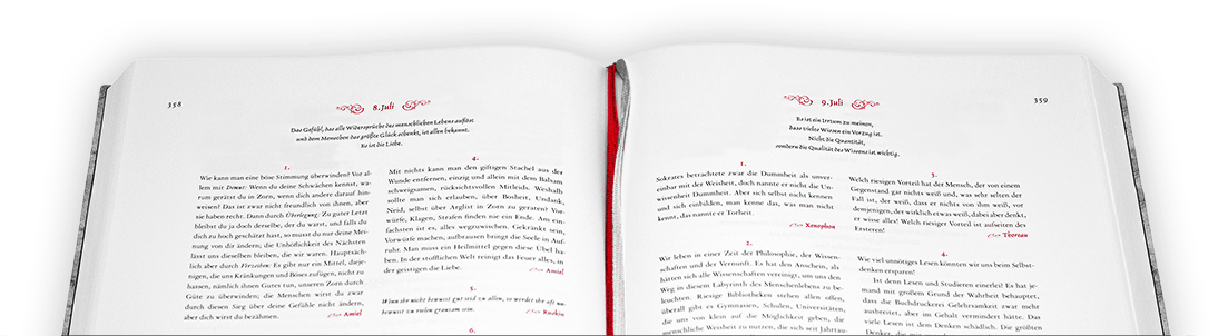 Ausschnitt eines mittig aufgeschlagenem Buches mit rotem Leseband in der Draufsicht